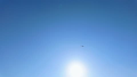 Airplane Soaring Across the Sky from a Distance