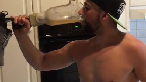 Man in hat drinks beer from prosthetic leg