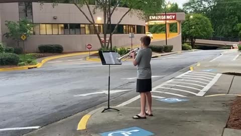 12-year-old boy plays trumpet for healthcare workers