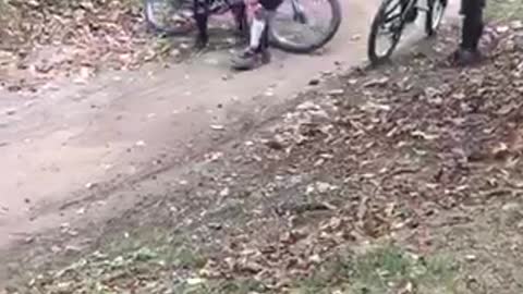 White helmet bmx rider falls down off dirt jump