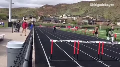 Red shirt guy jumping over hurdles with two hands falls down