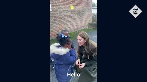 Princess Kate gives remembrance poppy to young boy during school visit