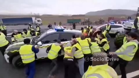 Spanish farmers move car causing a blockage