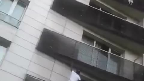 FRANCE — Young Man Scales Building In Seconds To Save Dangling Toddler!