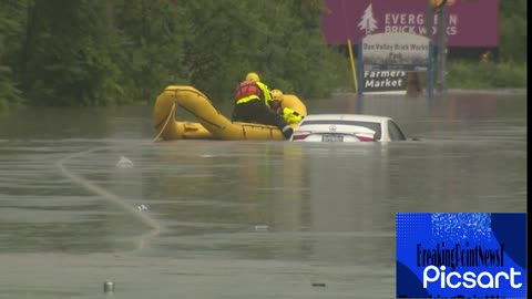 Toronto floods_ Emergency crews rescue driver stranded on top of car