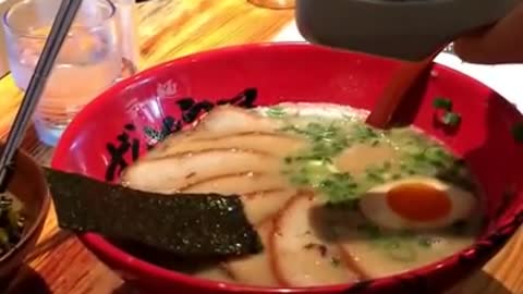 Squeezing garlic in Japanese Ramen