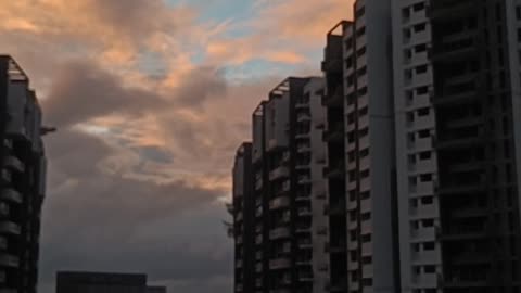 "Sunset Magic: Urban Beauty Behind the Buildings"