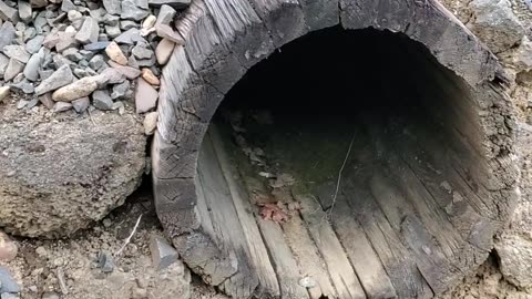 Wood Culvert under railroad Train track.