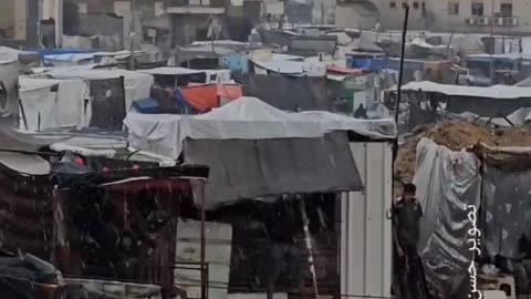 Difficult conditions for displaced people as rain falls on their flammable tents