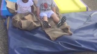 One black girl and one white boy having fun in an adventure park