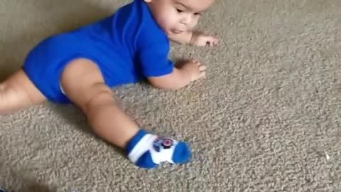 Baby Boy Spins Around Floor Chasing His Foot