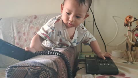 Cute Atharva trying to make a call to his :P