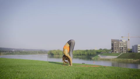 Woman doing yoga on the grass