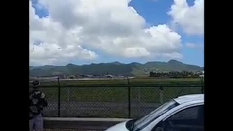 Plane taking off from st marteen airport near a beach