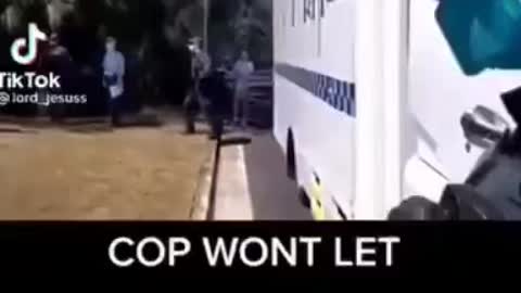 Aussie cop won’t let a paramedic treat an injured man.