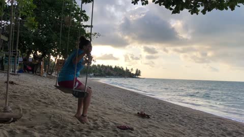 Woman Sitting On A Swing Hanging.