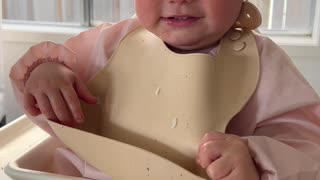 Baby Tries to Take Her Bib Off