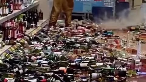 Woman Slowly Knocks Entire Shelves of Glass Bottles onto Floor, Slightly Injuring Self