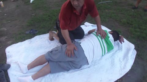 Luodong Briefly Massages Mexican Man In Green Striped Shirt At The Picnic