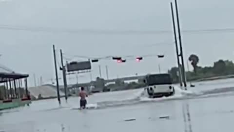 Water skiing down flooded street from Tropical Storm Imelda