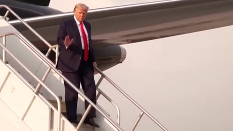 The 45th President exits Trump Force 1 and gives his supporters a thumbs up