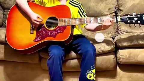 YOUNG BOY PLAYS GUITAR AND SINGS JOHNNY CASH