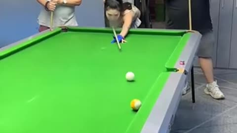 Beautiful girl plays billiard