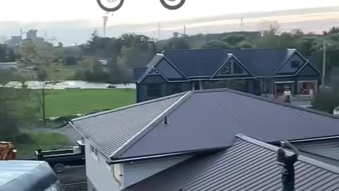 The person tossed the bike higher than the height of the house, then will not believe