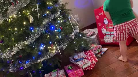 Little Girl opening Presents on Christmas Morning