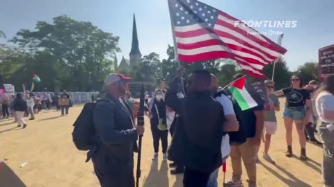 A DNC protester tries to steal an American flag from a black man at Union Park.