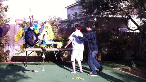 Blindfolded Man Trying To Hit Pinata Accidentally Throws Bat At Camera