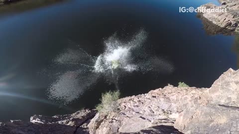 Guy black wetsuit back flip into lake