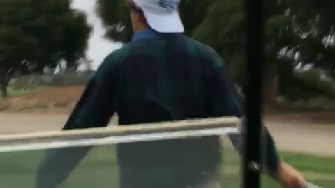 Golf cart runs into guy white cap