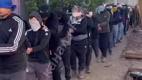 Israeli soldiers force prisoner to wear Israeli flag