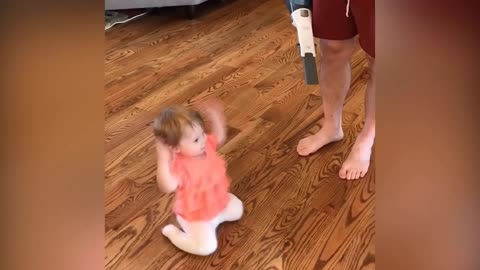 cute baby dancing on sound of Vacuum cleaner