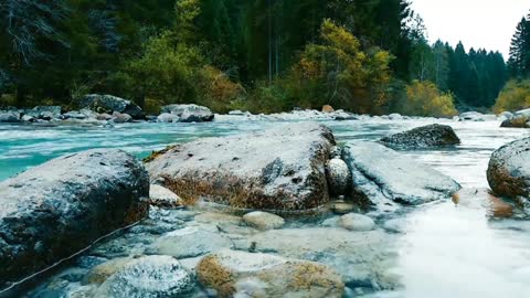 Sound of water running and wind blowing.