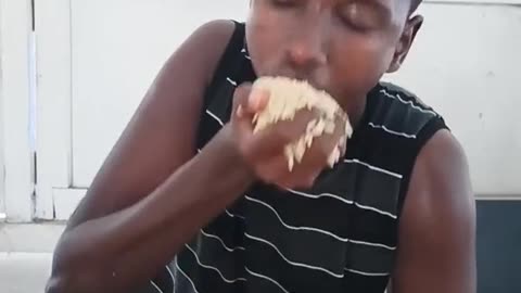 Funny african boy eating food