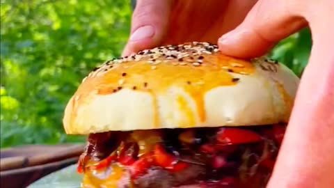 Cooking an unusual burger in the forest on a fire