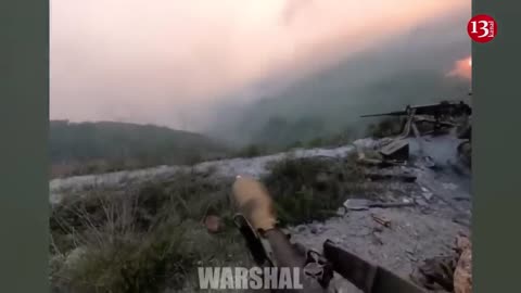 Ukrainian fighters hiding on hills open fire at the advancing Russians on the river bank