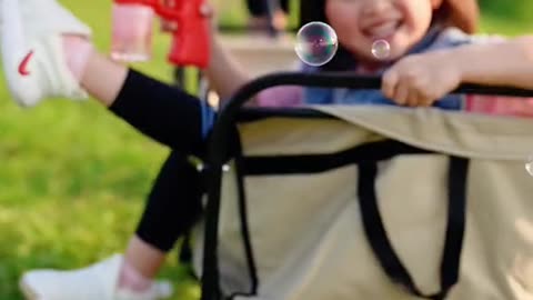 cute baby playing with bubble maker