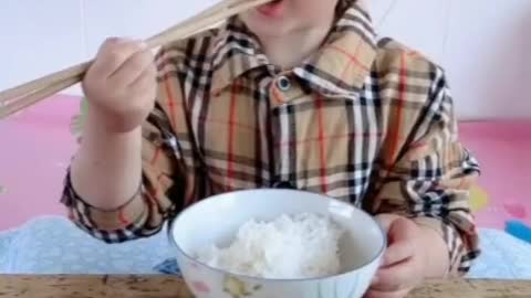 Cute Kid Eating with Sticks