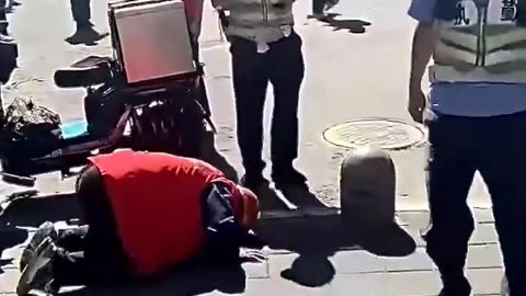 Delivery boy kneels in the street to CCP cops