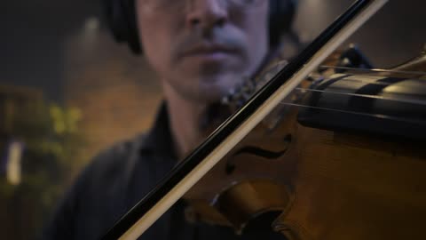 hands of a skilled violinist playing a piece