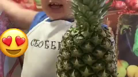 A child cutting fruit with his hands