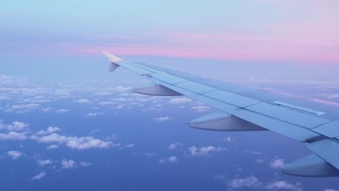 Pink sunset seen from a plane window