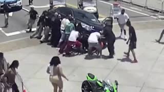 Onlookers & Police Come to the Rescue of Motorcyclist Trapped Beneath a Car