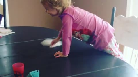 Sweet little girl loves helping mom clean the house