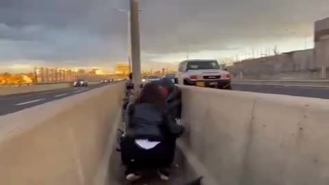 Residents take shelter in middle of road as warning sirens in Tel Aviv, Israel