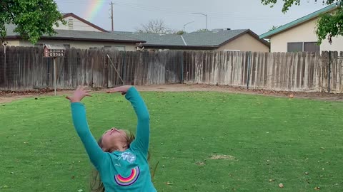 Kiddos Excited over Backyard Rainbow