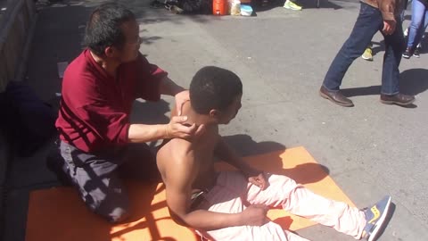 Luodong Massages Shirtless Black Man On Sidewalk